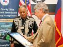 Harris County Judge Ed Emmett (right) presents Laugermann with a framed proclamation from the County in recognition of Laugermann’s accomplishments as a Volunteer Examiner.